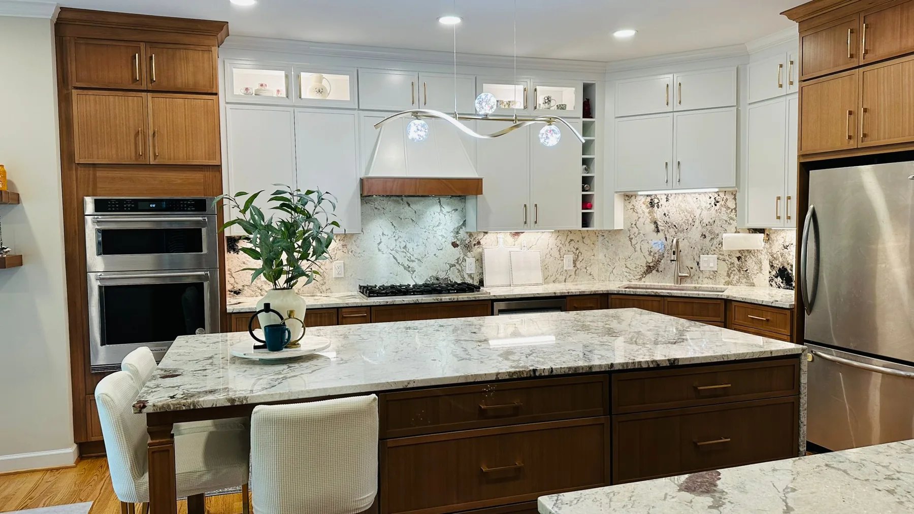 Completed kitchen with wood cabinetry and a large island