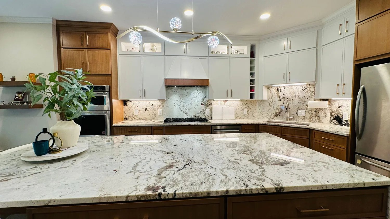 Kitchen with white cabinets and a wood island